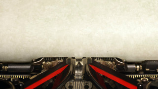 Old vintage typewriter with blank paper